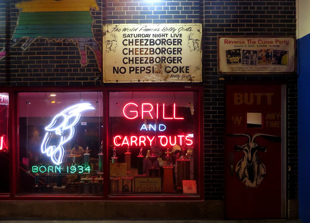 The goat-head neon, Cheezborger sign, and red door at Billy Goat Tavern
