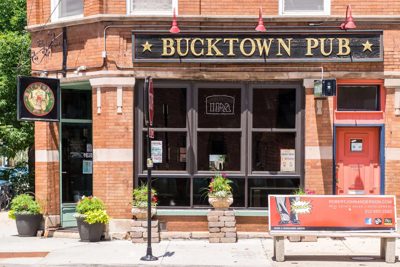 The brick Bucktown Pub storefront and hanging bicycle sign on Cortland Street