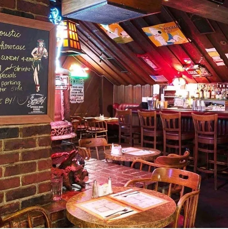 Cafe Brass Monkey bar with a wood-slat ceiling, pendant lights, and a backbar of bottles