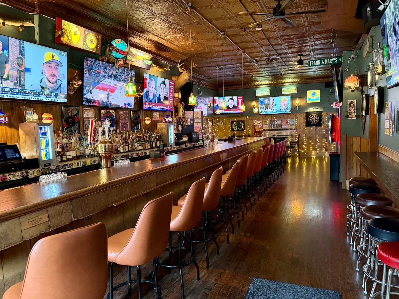 The long wooden rail, tin ceiling, and Old Style signs inside Frank & Mary's Tavern