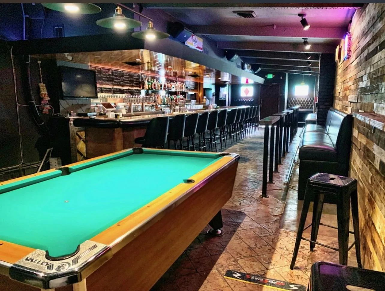 Gold Rail Bar with a pool table, wood-paneled walls, and a red-felt table
