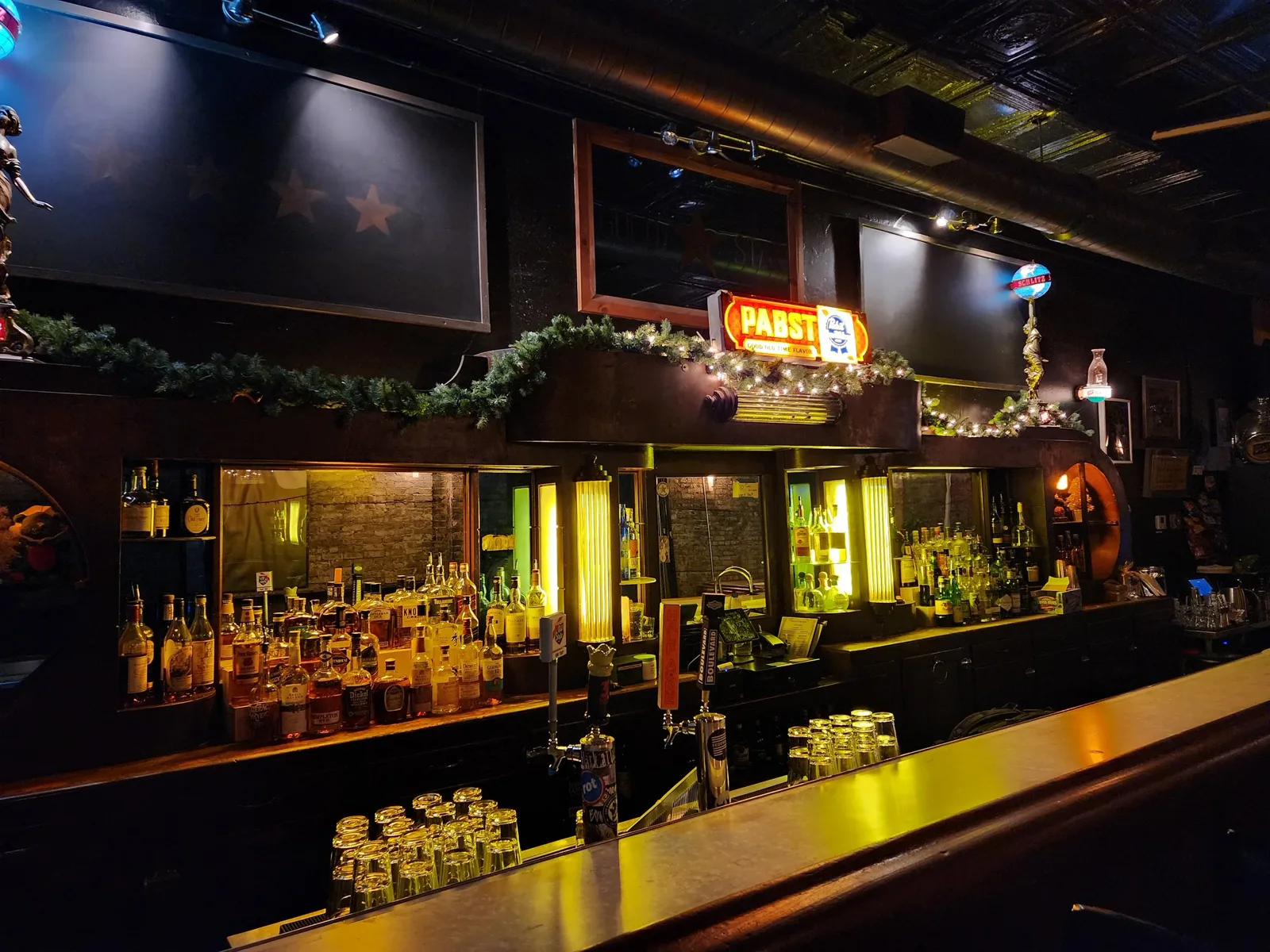 The Gold Star back bar, Pabst sign, liquor shelves, and holiday garland