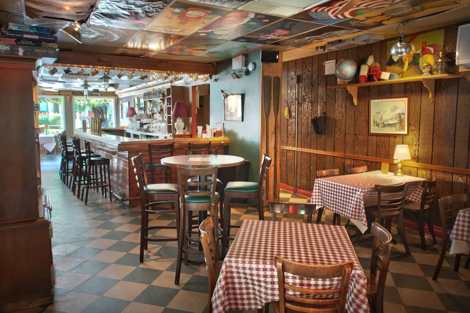 Checkered tablecloths, a round high-top, board games, and the painted Guthrie's Tavern ceiling in the back room