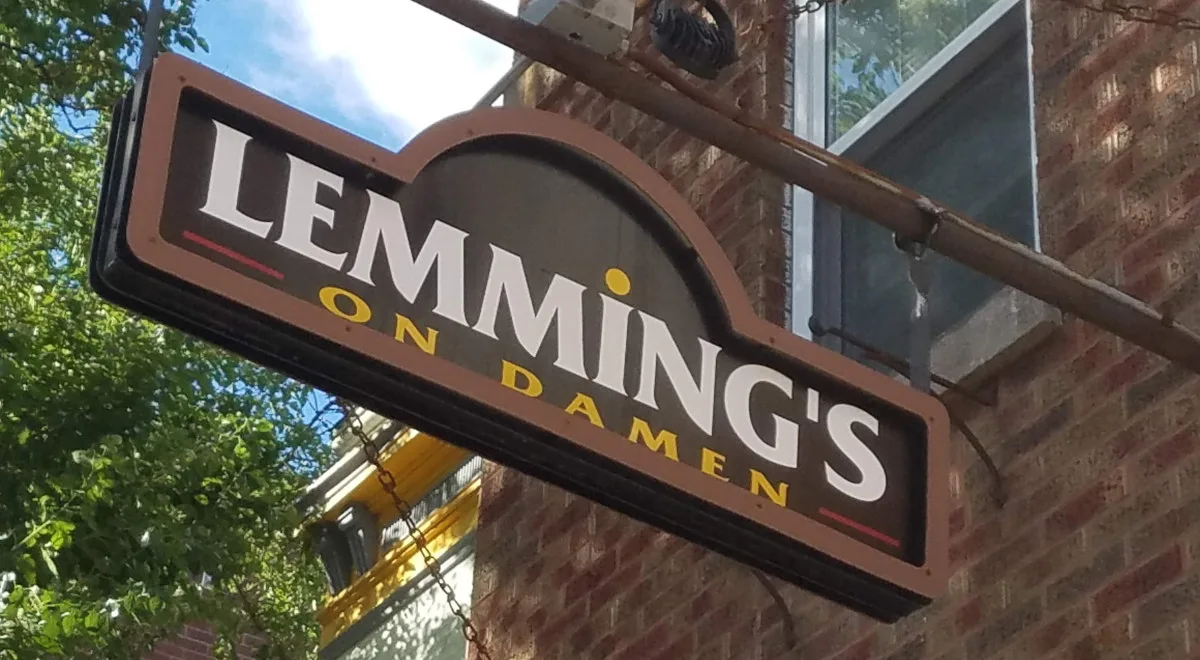 The hanging Lemming's on Damen sign on the brick tavern facade