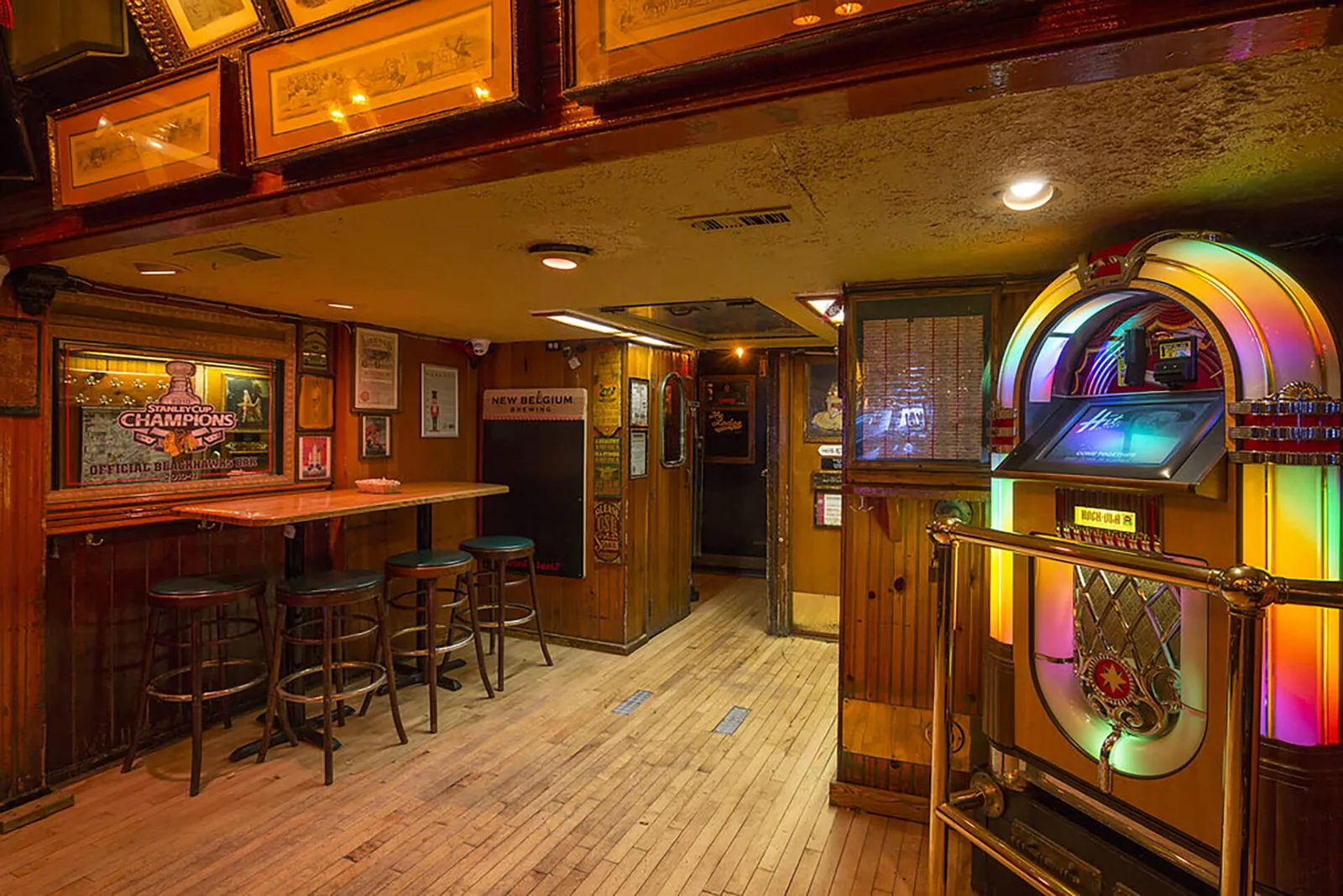 The Rock-Ola jukebox and wood-paneled hallway at Lodge Tavern