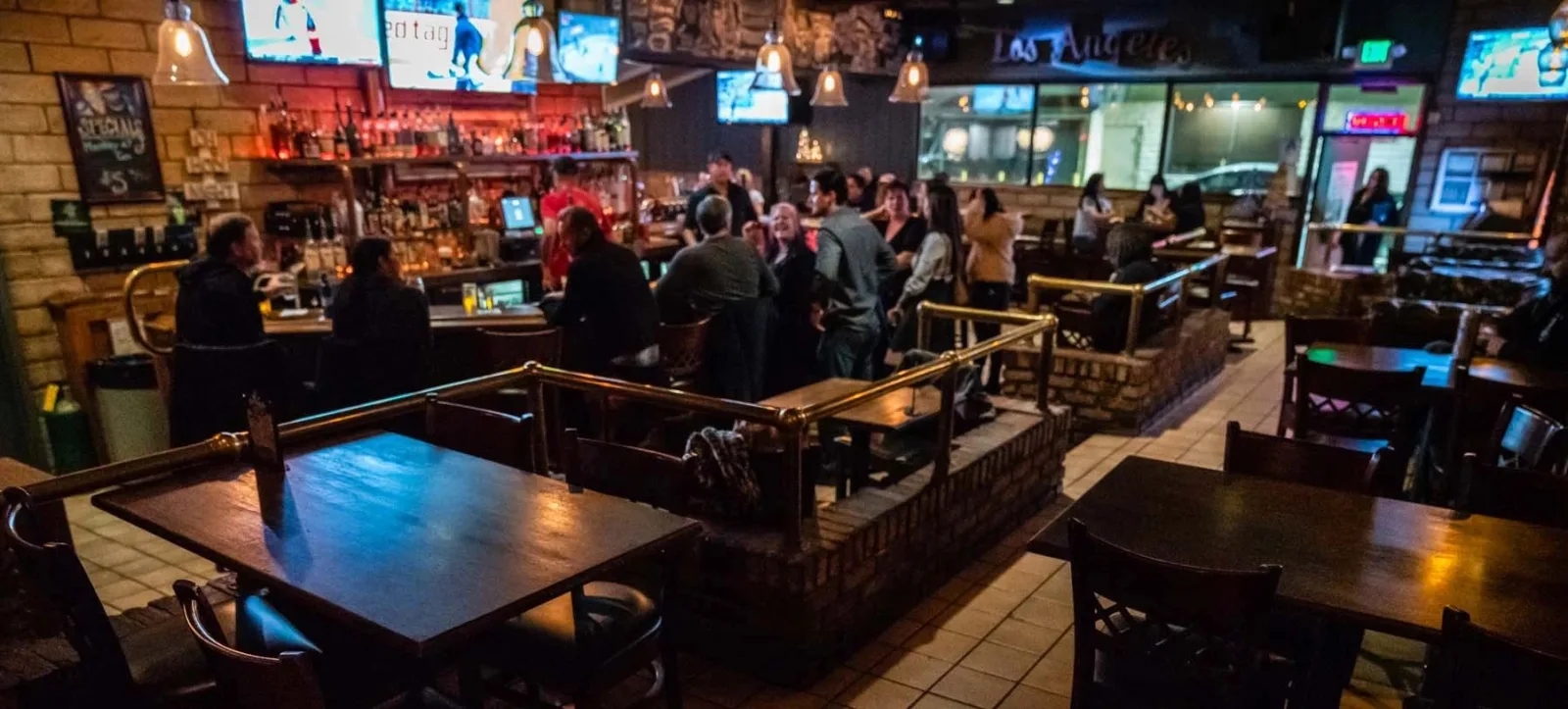 Residuals Tavern bar with a long counter, TVs, and a deep beer list