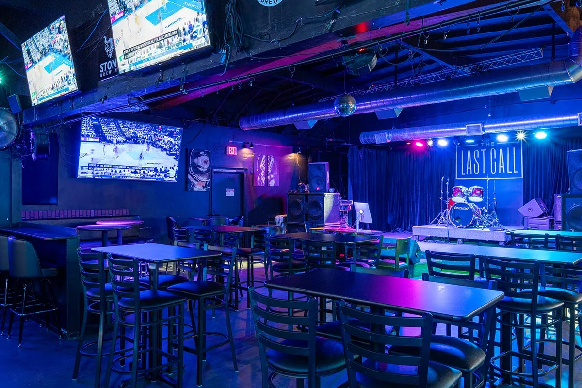 The Last Call bar with a pool table, TVs, and a glowing Last Call sign